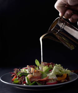 Close-up of hand pouring food