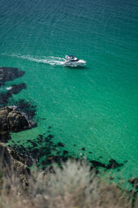 Yacht boat approaching beautiful bounty lagoon, cape fiolent in balaklava, sevastopol, russia. 