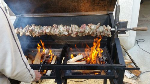 Man preparing food on barbecue grill