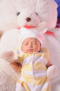 Cute baby girl sleeping on bed