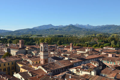 High angle view of town against blue sky