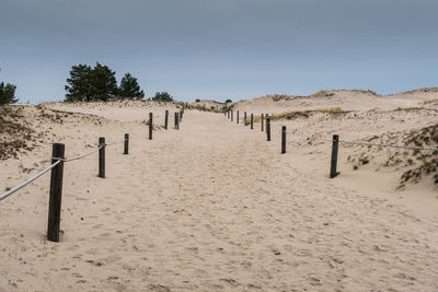 Panoramic view of sand dune against sky