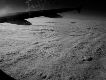 Cropped image of airplane flying over sea