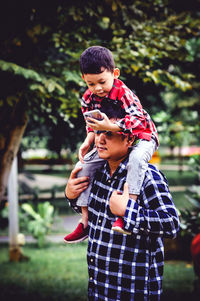 Cute boy with baby girl outdoors