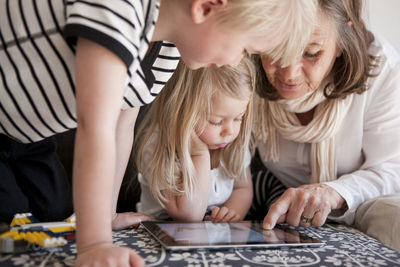 Grandmother with granddaughter using laptop