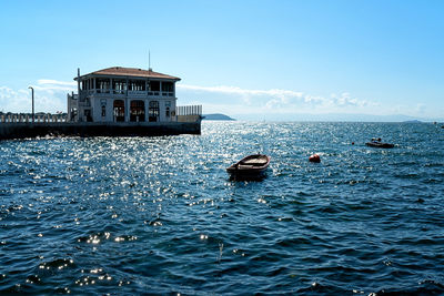 Boat in sea against building