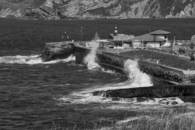 Scenic view of sea against buildings