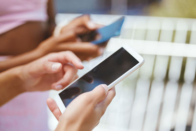 Midsection of woman using mobile phone