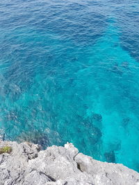 High angle view of rock formation by sea