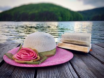 Close-up of hat on beach against lake