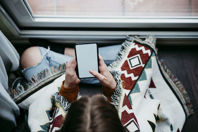 Midsection of person using mobile phone