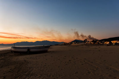 Scenic view of beach against sky during sunset