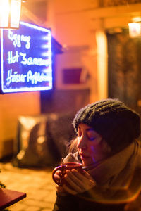 Portrait of young woman with illuminated text