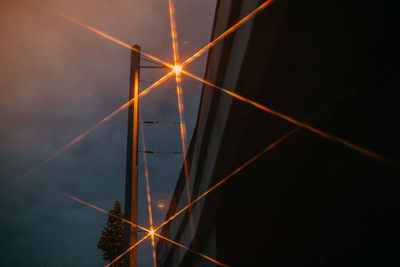 Low angle view of light trails against sky at night