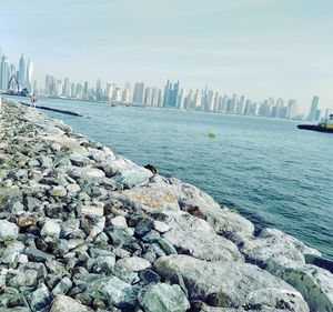 Scenic view of sea and buildings against sky