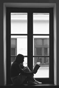 Woman looking through window