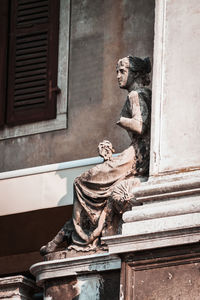 Statue against building