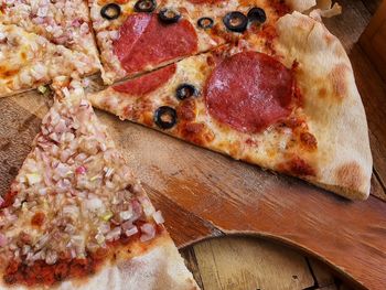 High angle view of pizza on cutting board