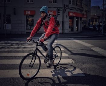 Woman standing on road in city