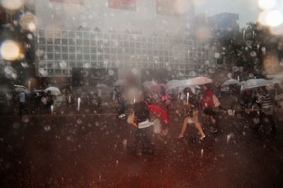 People walking on wet street in rain