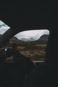 Rear view of woman sitting in car