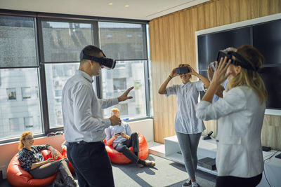 Colleagues wearing vr glasses in office