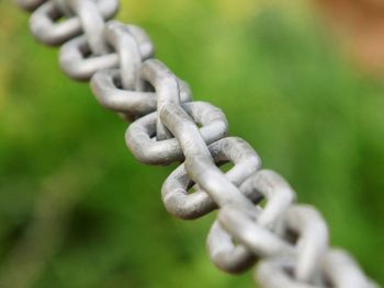 Close-up of chain tied to metal