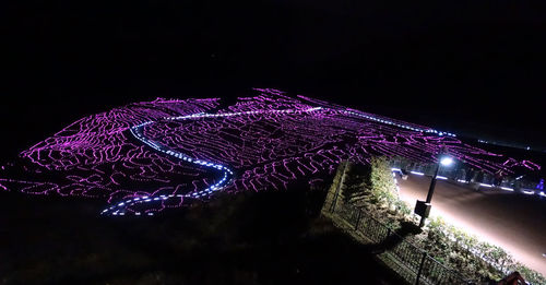 Low angle view of illuminated sky at night