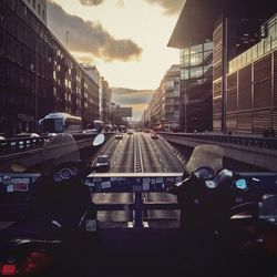 Cars on street amidst buildings in city