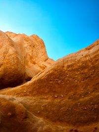 Rock formations against clear blue sky