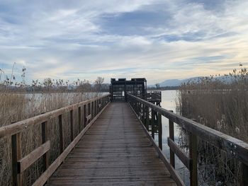 Bridge over calm sea against sky