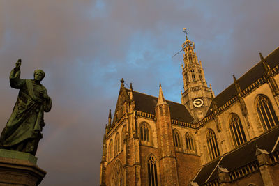 Low angle view of statue of temple against cloudy sky