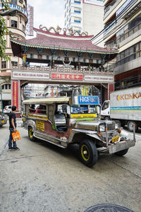 Vehicles on road along buildings