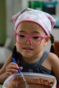 Close-up of cute girl preparing food on table