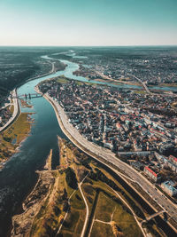 High angle view of sea and buildings against sky