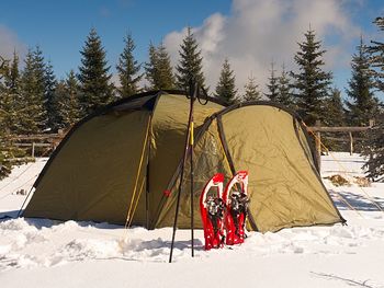 Tent in snow covered field