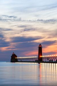 Pier over sea against sky during sunset