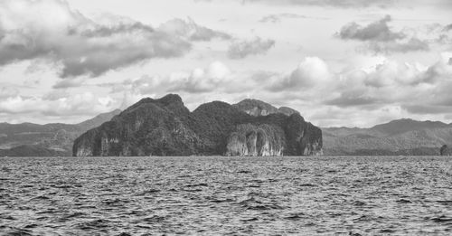 Scenic view of sea and mountains against sky