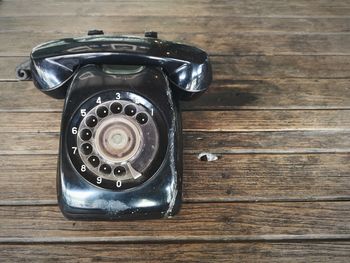 High angle view of old telephone on table
