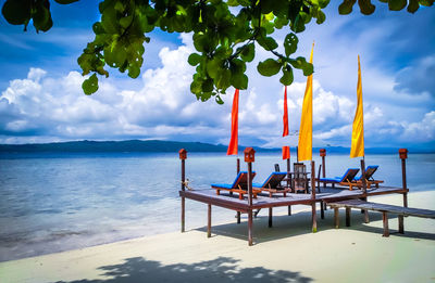Lifeguard hut on beach against sky