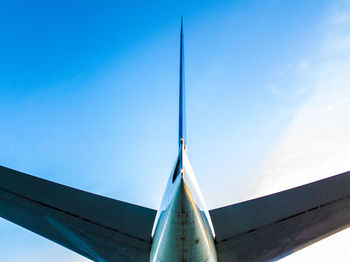 Low angle view of airplane against blue sky
