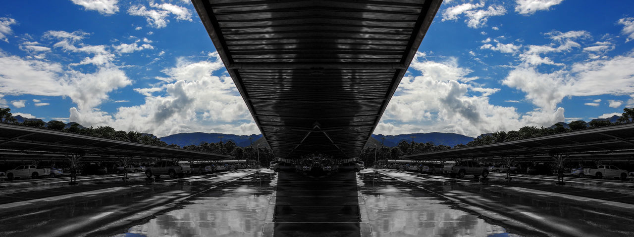 LOW ANGLE VIEW OF BRIDGE AGAINST CLOUDS