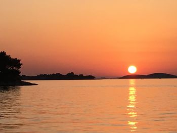 Scenic view of sea against romantic sky at sunset