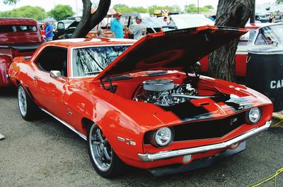 Close-up of red car on street