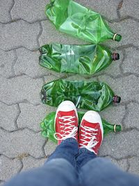 Low section of person standing on bottles