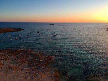 Scenic view of sea against clear sky during sunset