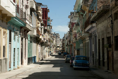 Cars on street amidst buildings in city