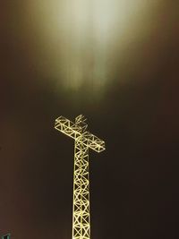 Low angle view of illuminated christmas lights against sky at night