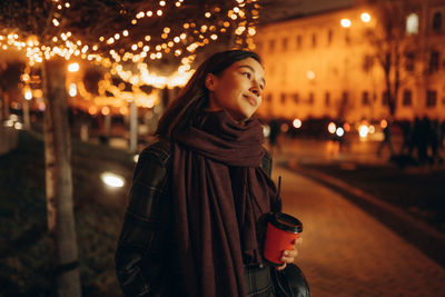 Happy woman at the christmas market at night