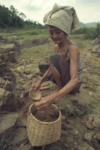 Man working in basket on field